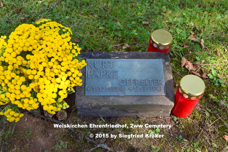 A view during one summer morning from inside the war cemetery in Weiskirchen towards the grave of Papke Kurt, ✞ Final gravesite: Block 1 Row 9 Grave 18.